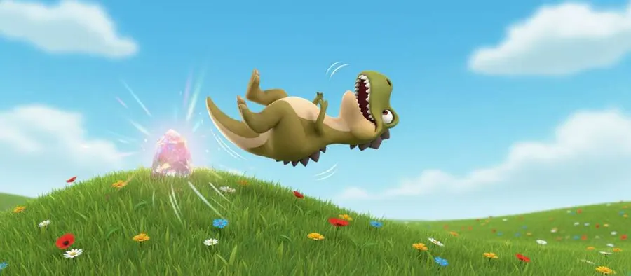 Un dinosaurio verde sale despedido por los aires tras tropezar con una piedra en lo alto de una colina